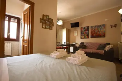 a room with a bed with towels on it at Margherita Holiday Home in Rome