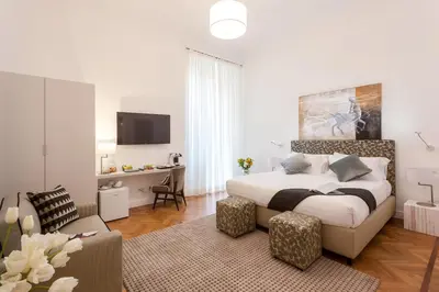 a bedroom with a bed and a living room at 504 Corso Suites in Rome