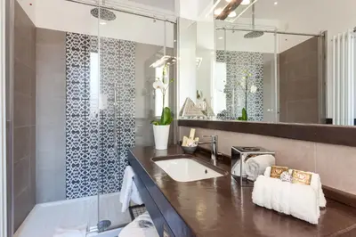 a bathroom with a sink and a large mirror at 504 Corso Suites in Rome
