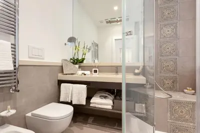 a bathroom with a toilet and a sink and a shower at 504 Corso Suites in Rome