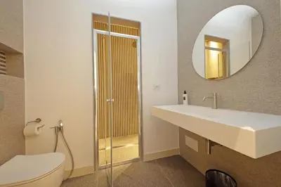 a bathroom with a sink and a toilet and a mirror at Velvet Inn in Rome