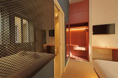 a room with a bed and a tv in it at Velvet Inn in Rome