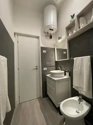a bathroom with a white toilet and a sink at Appartamento San Lorenzo di Massimo & Luisa in Rome