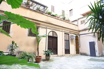 an old building with plants in front of it at Appartamento San Lorenzo di Massimo & Luisa in Rome