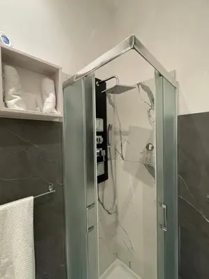 a shower with a glass door in a bathroom at Appartamento San Lorenzo di Massimo & Luisa in Rome
