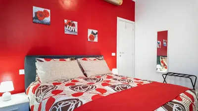 a red bedroom with a bed with a red wall at Il Sogno Romano in Rome