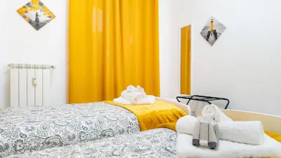 two beds with towels on top of them in a room at Il Sogno Romano in Rome