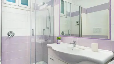 a bathroom with a sink and a glass shower at Il Sogno Romano in Rome