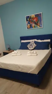 a bed in a room with a blue wall at 102 DreamHouse metropolitana B Libia in Rome