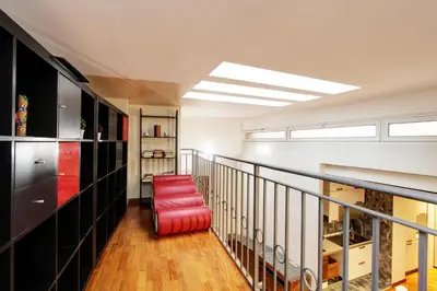 a room with a staircase with a red stool at San Lorenzo Elegante loft in Rome