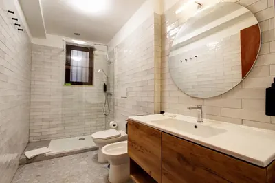 a bathroom with a sink and a toilet and a mirror at San Lorenzo Elegante loft in Rome