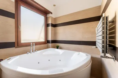 a bathroom with a white sink and a window at Cielo Suite, Panoramic Apt View with Jacuzzi in Rome