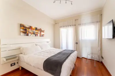 a white bedroom with a large bed and a window at Cielo Suite, Panoramic Apt View with Jacuzzi in Rome