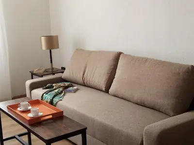 a living room with a couch and a coffee table at Appartement familial au coeur de Rome in Rome