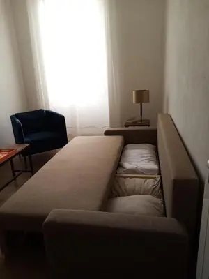 a couch in a living room with a window at Appartement familial au coeur de Rome in Rome