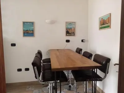 a conference room with a wooden table and chairs at Appartement familial au coeur de Rome in Rome