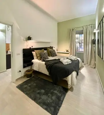 a bedroom with a large bed and a large window at Mazzini ApartmenT, next to Vatican City in Rome