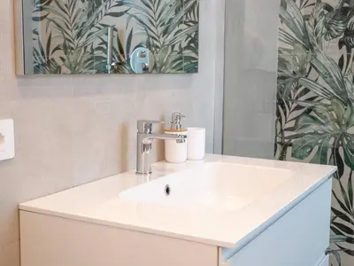 a bathroom with a white sink and a mirror at Flaminia Garden Suite in Rome
