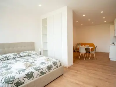 a bedroom with a bed and a table with chairs at Flaminia Garden Suite in Rome