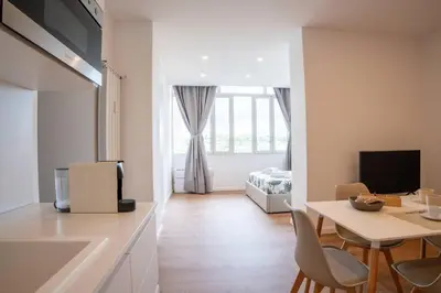 a kitchen and living room with a table and chairs at Flaminia Garden Suite in Rome