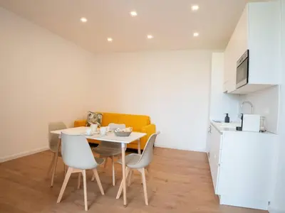 a kitchen with a table and chairs in a room at Flaminia Garden Suite in Rome