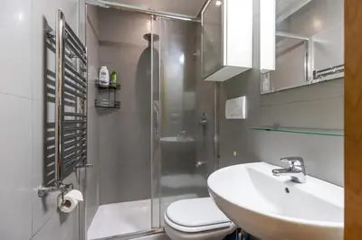 a bathroom with a shower and a sink and a toilet at Monti House - City Center in Rome
