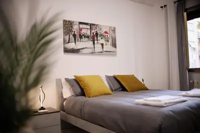 a bed in a bedroom with a painting on the wall at A Casa di Rocco in Rome