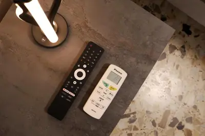 two remote controls sitting on top of a table at A Casa di Rocco in Rome