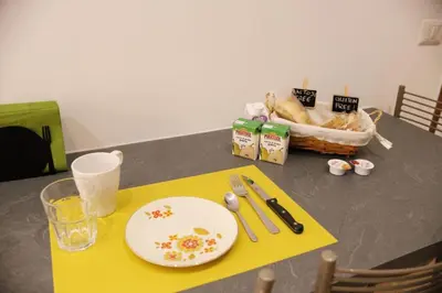 a table with a plate of food and a basket of bread at A Casa di Rocco in Rome
