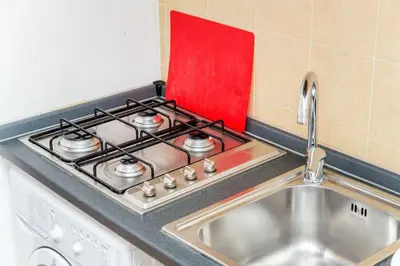 a kitchen with a stove top with a sink at Piazza NAVONA - CAMPO dei FIORI in Rome