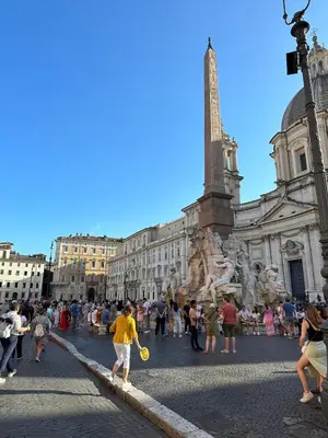 a person playing frisbee in front of a building at Piazza NAVONA - CAMPO dei FIORI in Rome