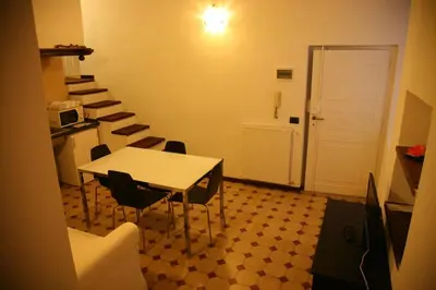 a room with a table and chairs and a staircase at Piazza NAVONA - CAMPO dei FIORI in Rome