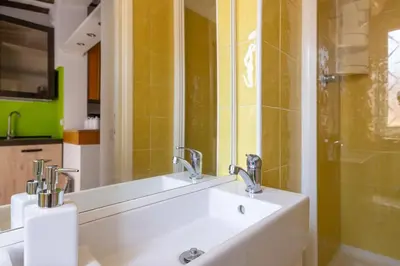 a bathroom with a sink and a mirror at Fascinating attic - up to 2 guests - Trastevere in Rome