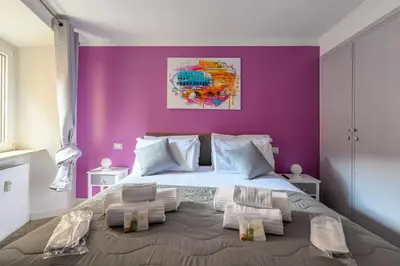 a bedroom with a large bed with purple walls at Historic Center - Navona Luxe Haven - Elevator, Soundproof & Netflix in Rome