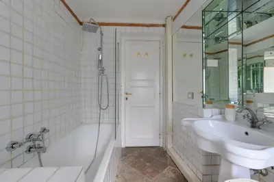 a bathroom with a tub and a sink and a shower at Historic Center - Navona Luxe Haven - Elevator, Soundproof & Netflix in Rome