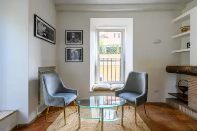 a living room with two chairs and a glass table at Historic Center - Navona Luxe Haven - Elevator, Soundproof & Netflix in Rome