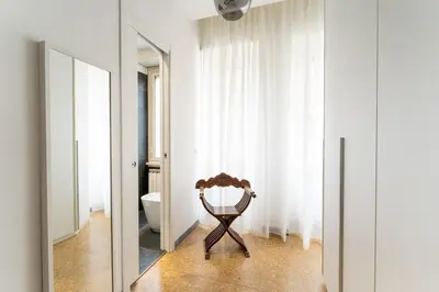 a wooden chair in a bathroom with a mirror at MP House in Trastevere in Rome
