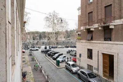a city street with cars parked in a parking lot at MP House in Trastevere in Rome