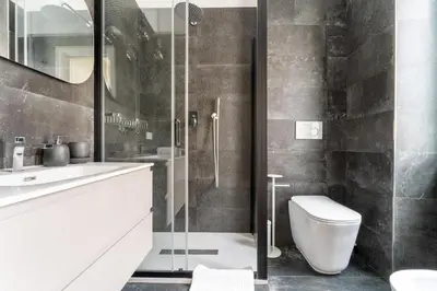 a bathroom with a toilet and a glass shower at MP House in Trastevere in Rome