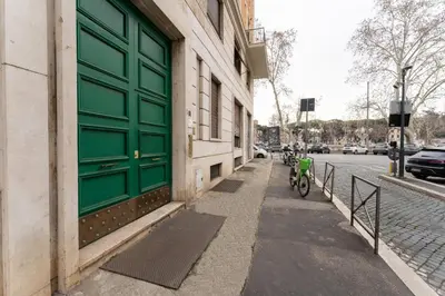 a bike parked next to a building with a green door at MP House in Trastevere in Rome