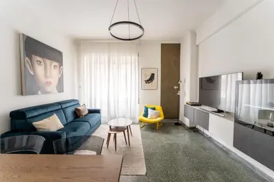 a living room with a blue couch and a tv at MP House in Trastevere in Rome