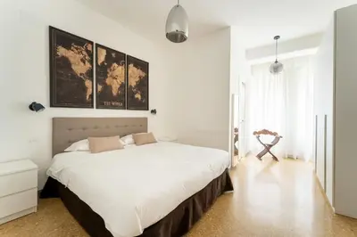 a white bedroom with a large white bed in it at MP House in Trastevere in Rome