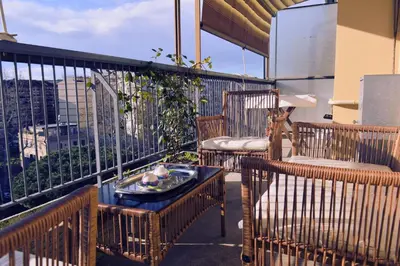 a balcony with chairs and a table on a balcony at Appia Sweet Home in Rome