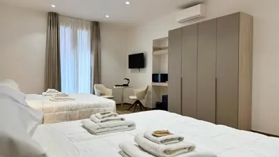 a hotel room with two beds with towels on them at Chich Suites in the Heart of Historic Rome in Rome