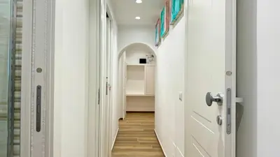 a hallway with a door leading to a bathroom at Chich Suites in the Heart of Historic Rome in Rome