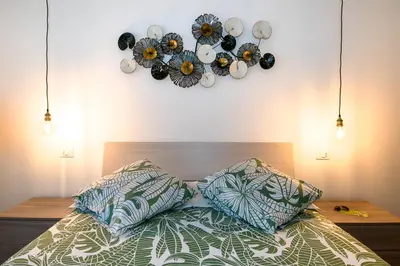 a bedroom with a bed with two pillows and a clock on the wall at Una stanza alPigneto in Rome