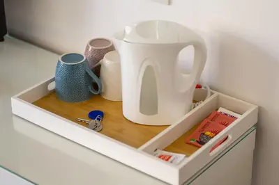 a drawer in a cabinet with a jug and cups at Una stanza alPigneto in Rome