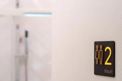 a black sign with the number on it next to a door at Una stanza alPigneto in Rome