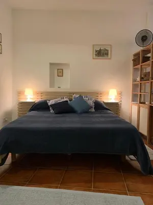 a bedroom with a large bed with blue blankets and pillows at Ideal for your Roman Holidays in Rome