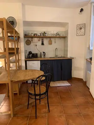 a kitchen with a table and chairs in a room at Ideal for your Roman Holidays in Rome
